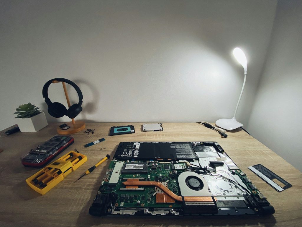 a table with a laptop and headphones on it